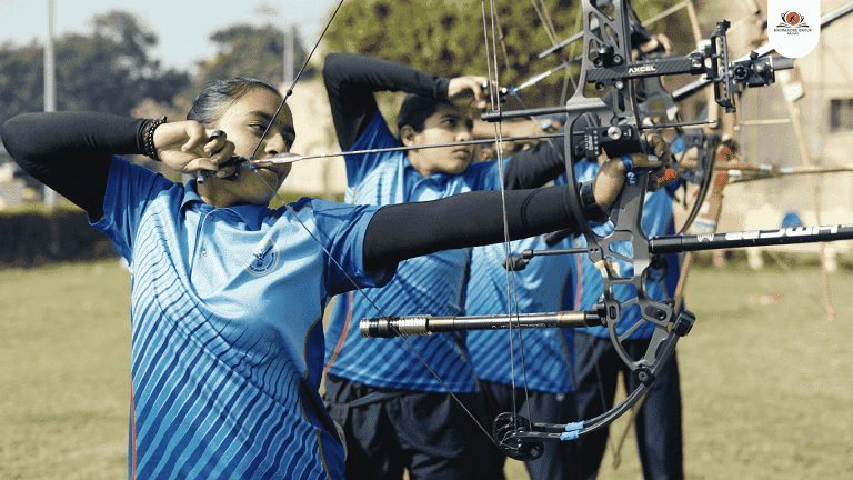 A student practicing archery, captured during a school documentary video production, highlighting extracurricular excellence